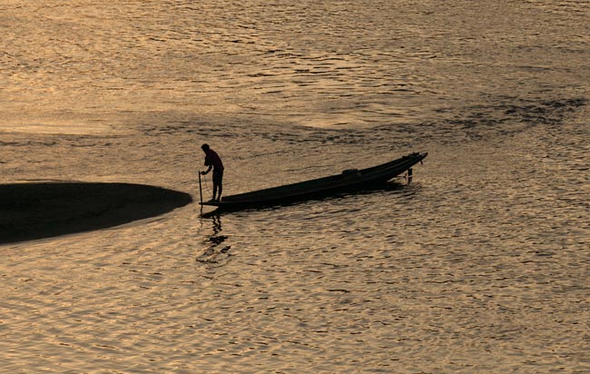 A fisherman at sunset from the bridge